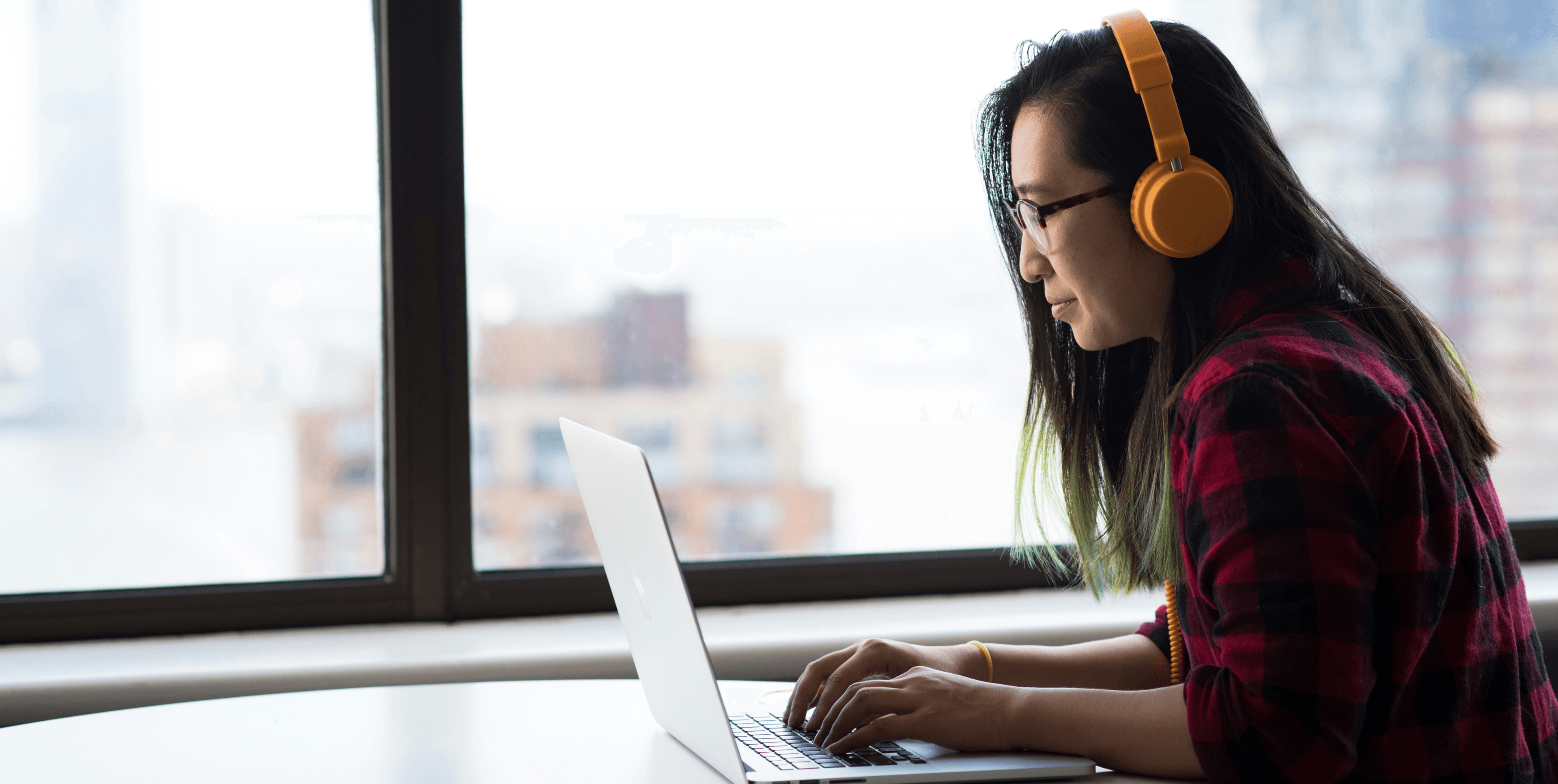 Woman learning online with headphones